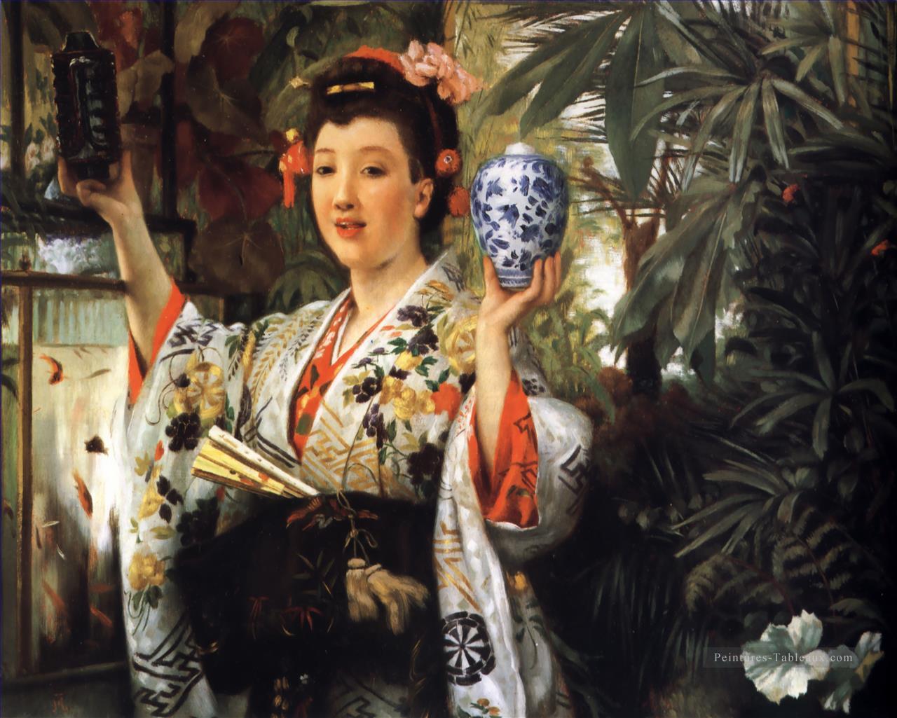Jeune femme tenant des objets japonais James Jacques Joseph Tissot Peintures à l'huile